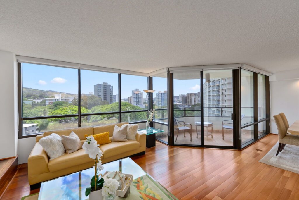 Living room with large picture windows and indoor-outdoor living design.