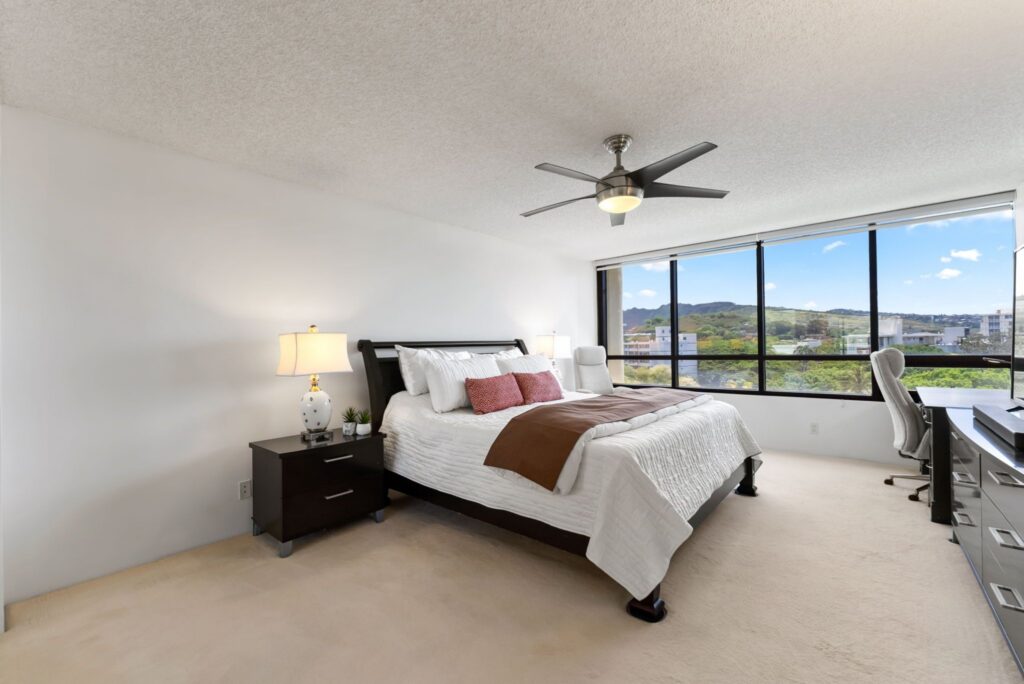 Spacious primary bedroom with mountain views and room for a sitting area.