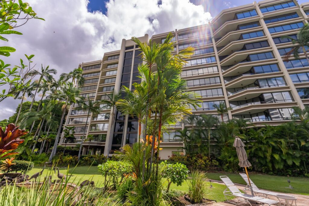 Exterior view of Punahou Cliffs condominium surrounded by tropical landscaping.