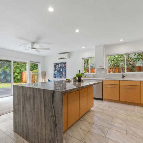 Modern Kaneohe kitchen with large island and backyard access.