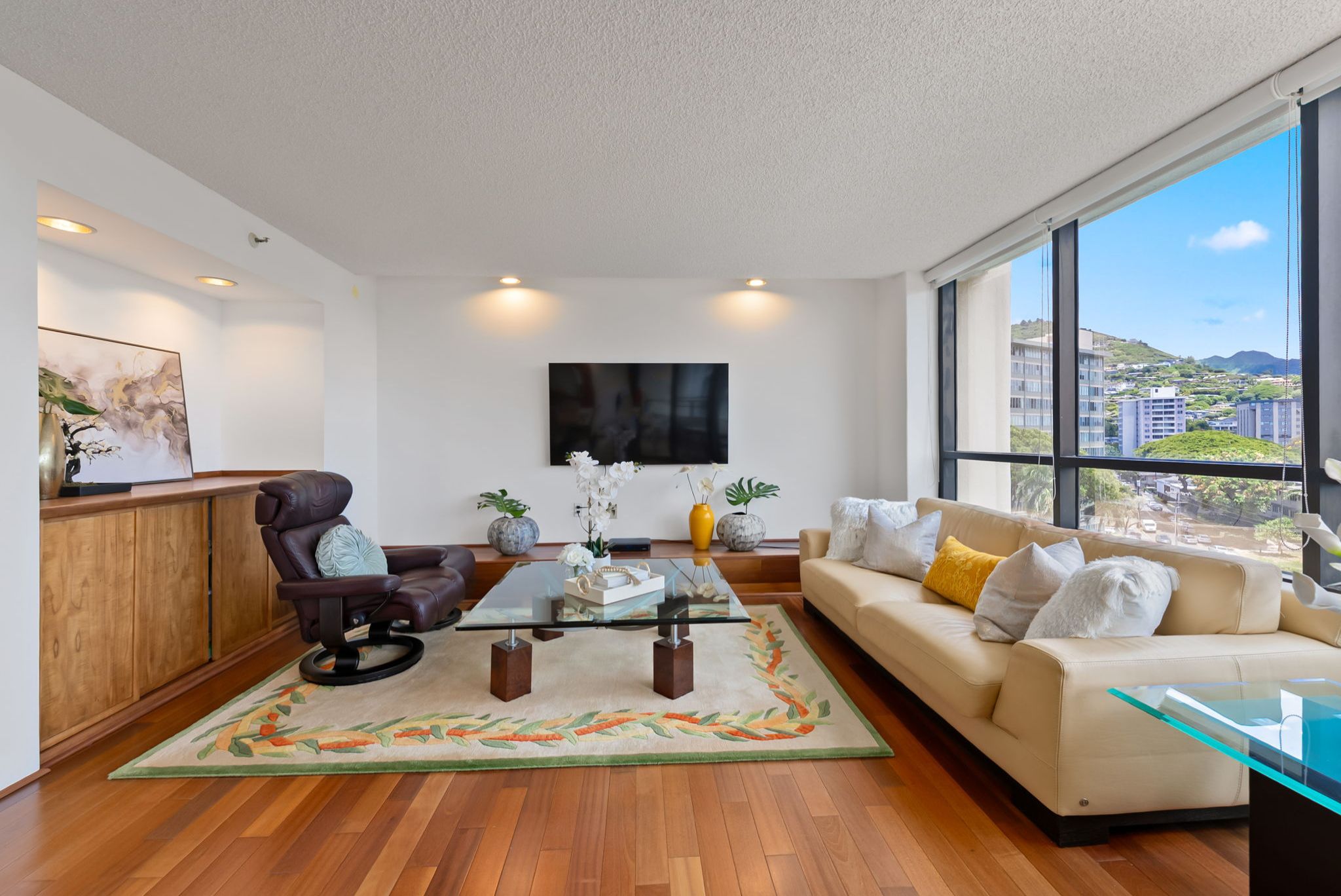 Spacious living area featuring Koa wood built-ins and expansive Honolulu views at Punahou Cliffs #905