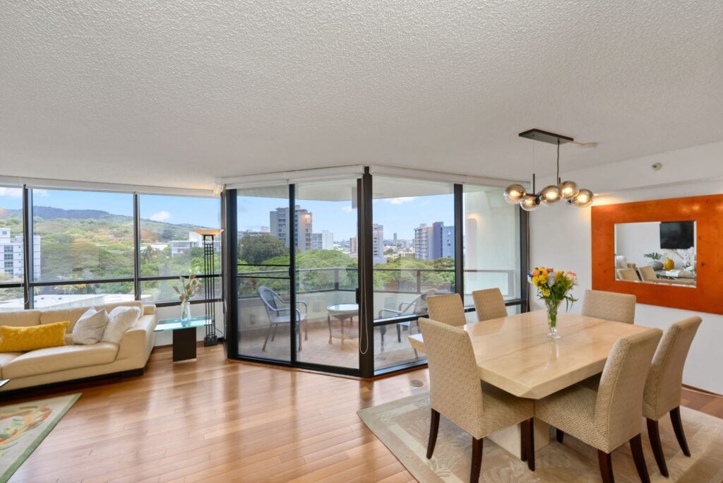 Open-concept living and dining area with lanai access and scenic views.