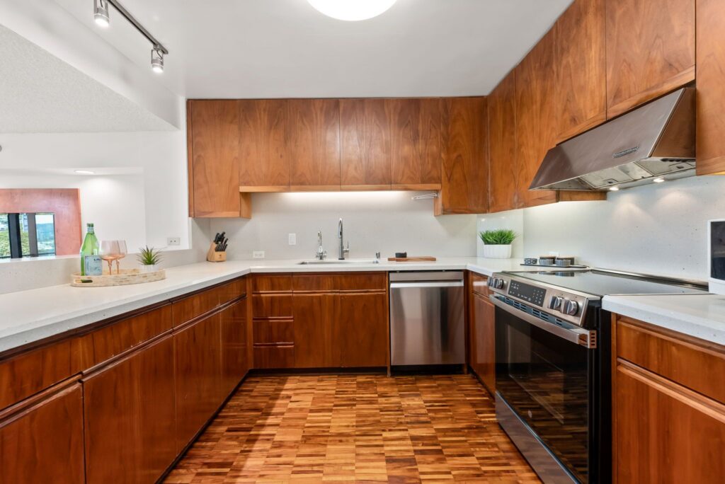 Updated kitchen with rich Koa cabinetry, upgraded countertops, and newer appliances.