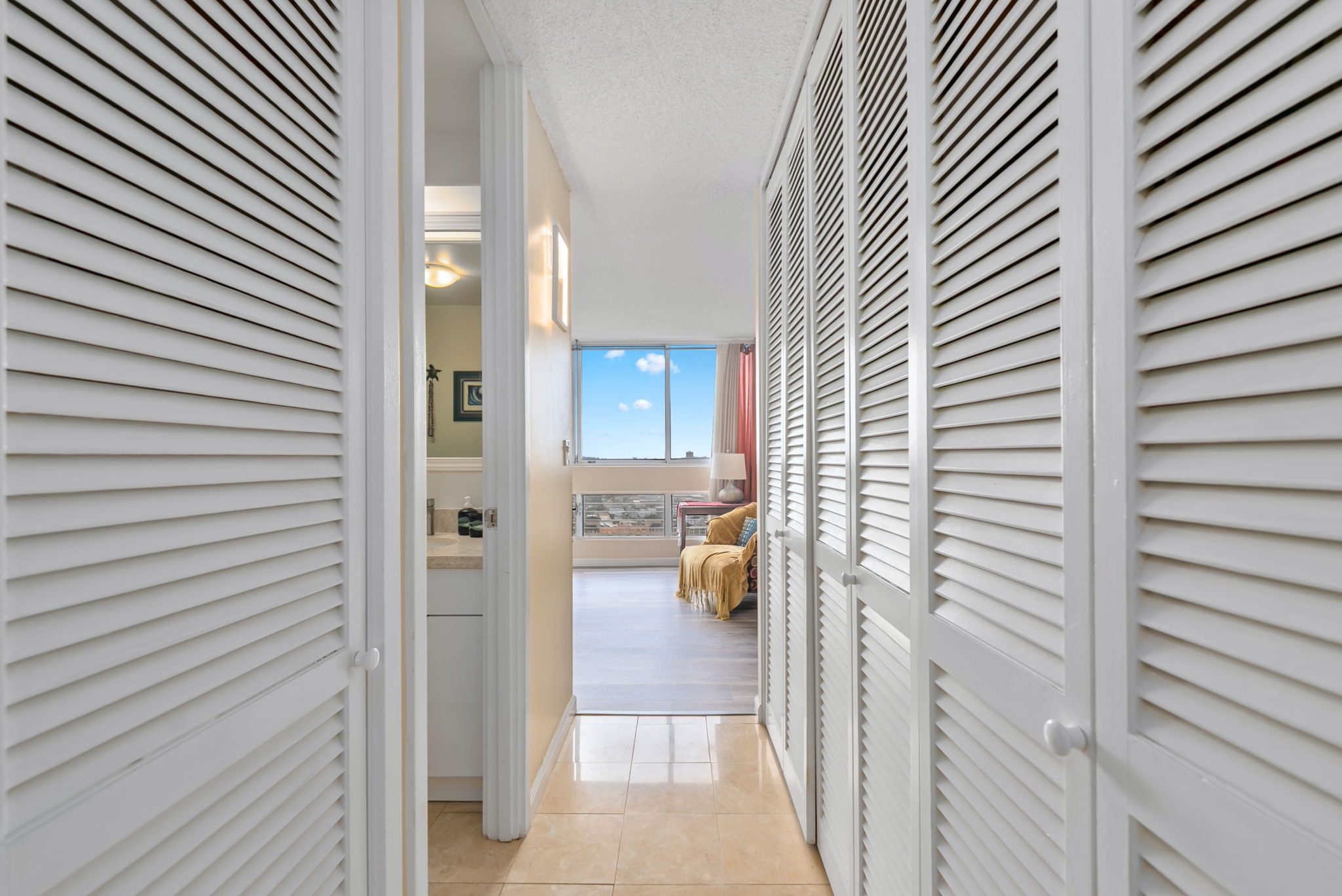 Hallway with closets leading to the bedroom at a condo in Honolulu