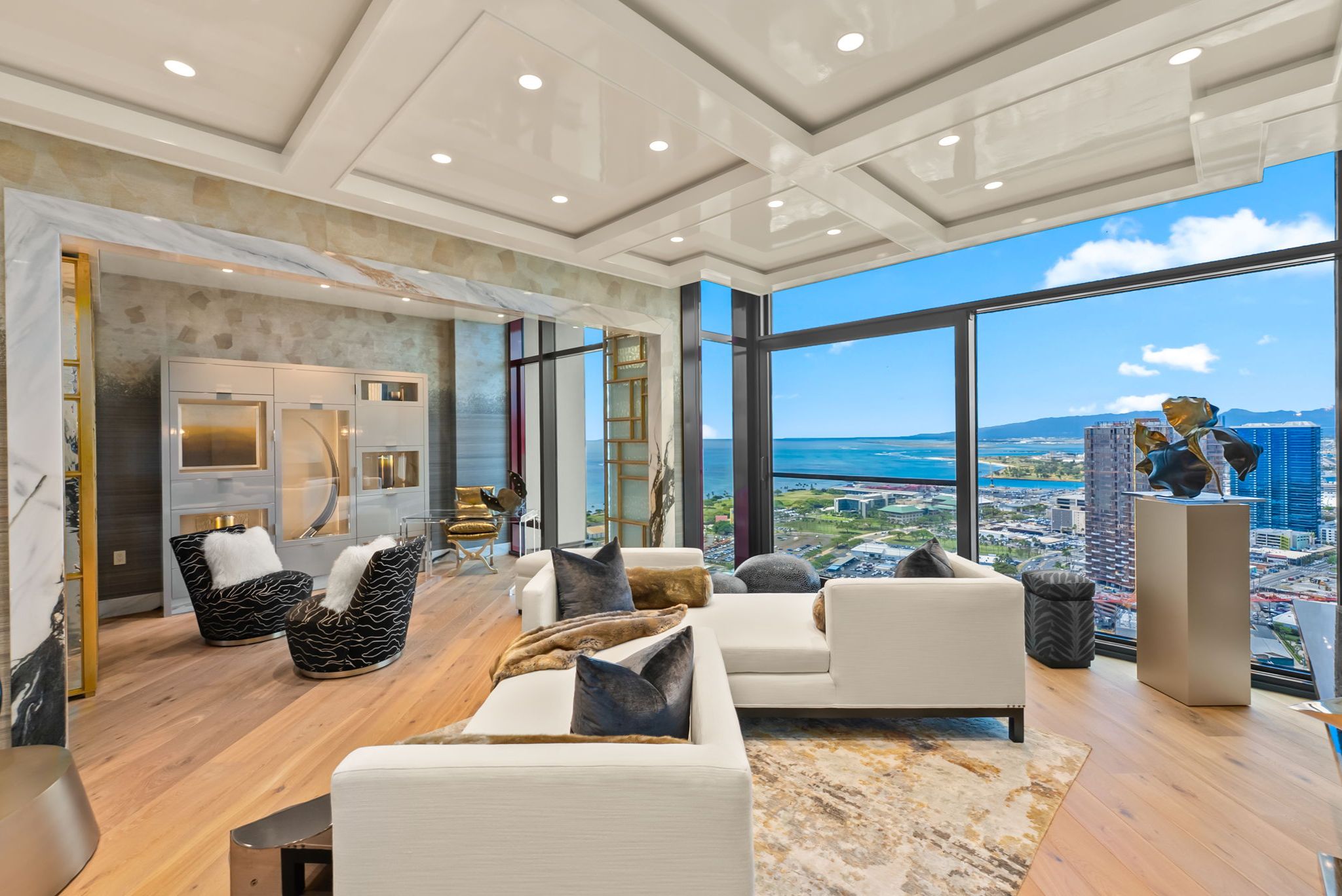 Grand Penthouse 4003 living room with floor-to-ceiling windows overlooking the ocean and Honolulu coastline