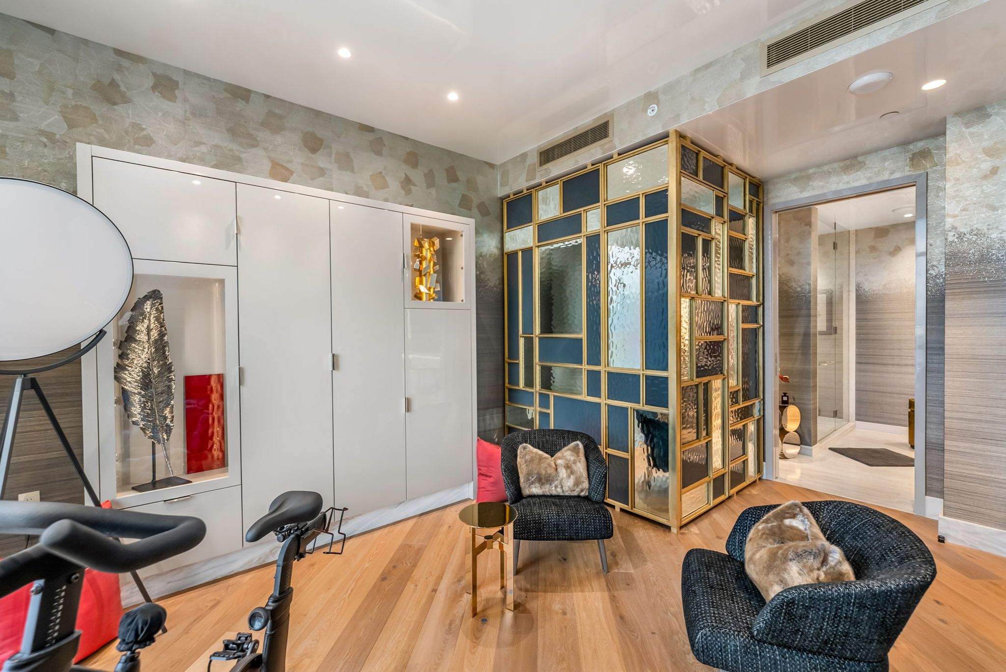 Custom bedroom cabinetry and brass-framed glass details inside