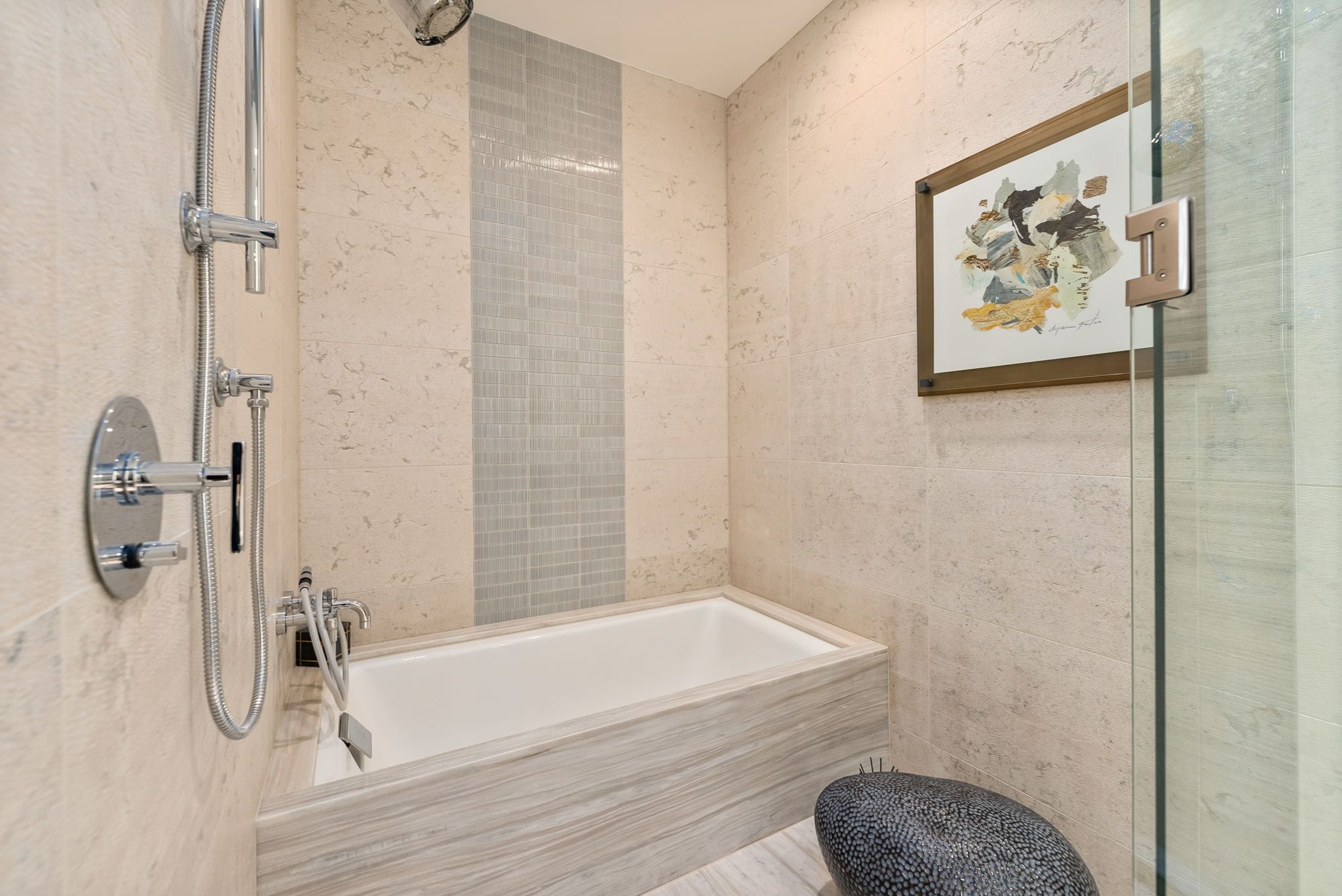 Bathroom with soaking tub, stone finishes and glass shower