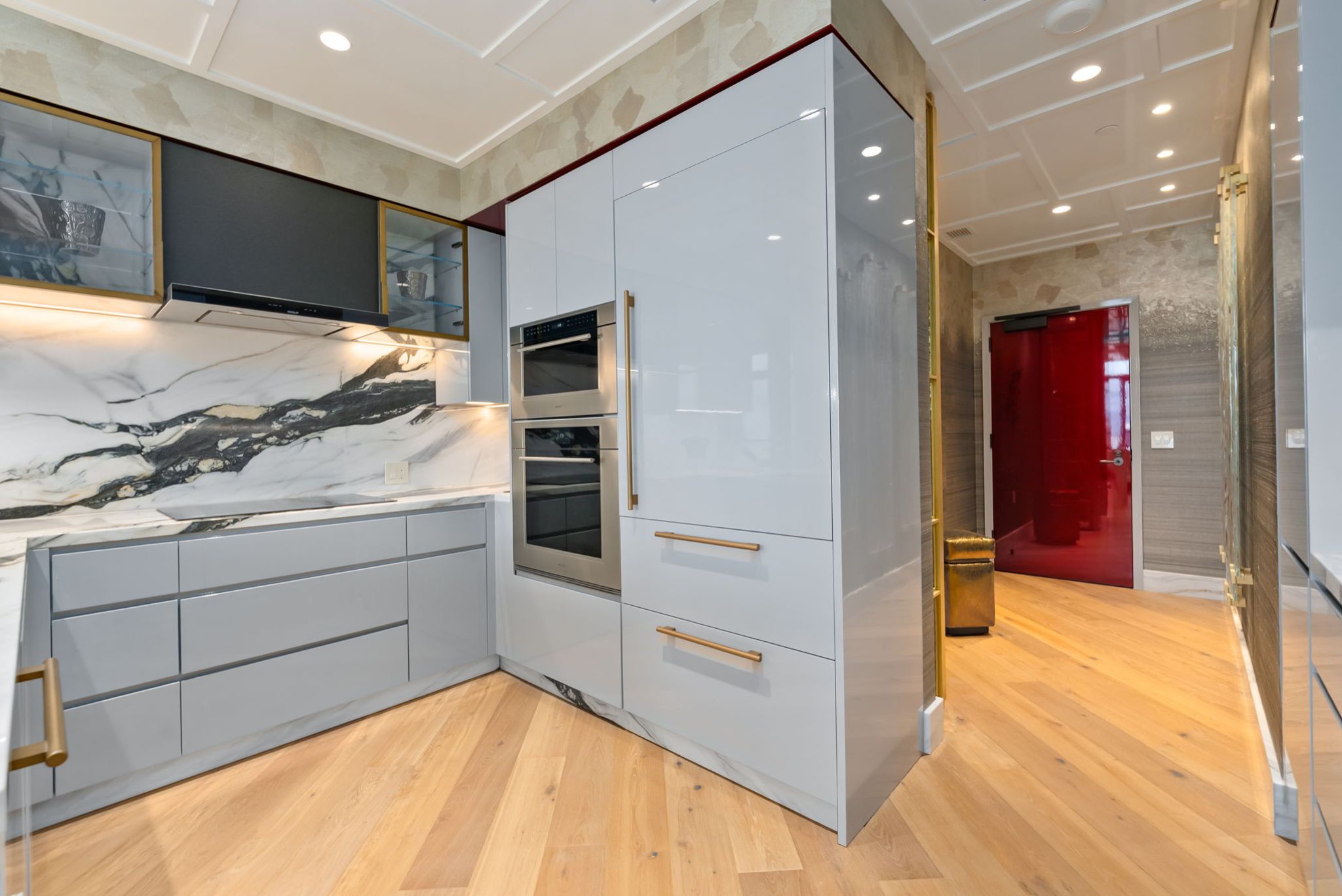 Custom kitchen cabinetry and rare Italian marble backsplash in Victoria Place Grand Penthouse 4003