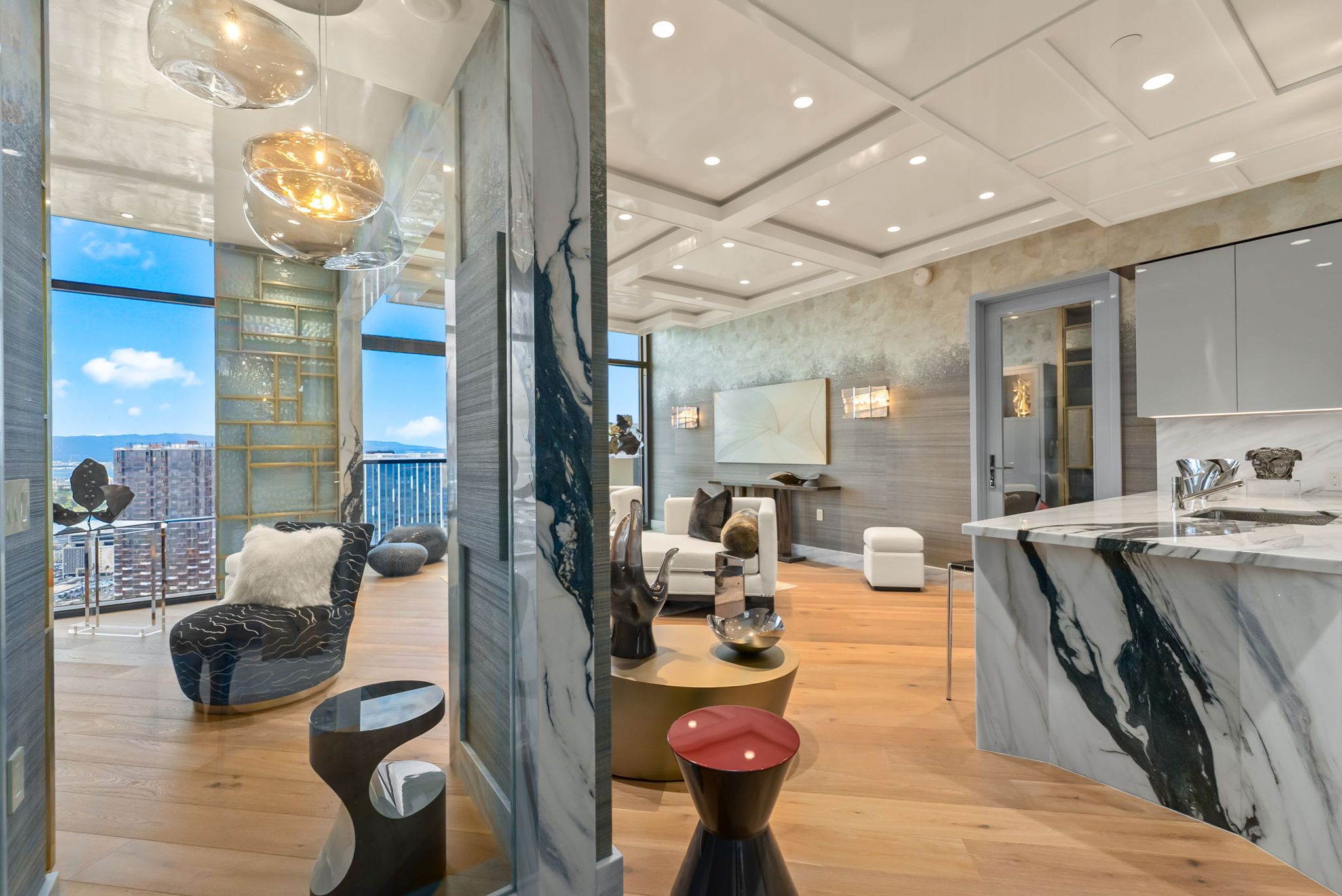 Open living and kitchen area at Victoria Place Grand Penthouse 4003 featuring rare Italian marble and ocean views